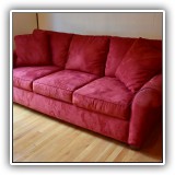 F12. Bauhaus red ultrasuede sofa. Dimensions: 89"W x 37.5"D x 33.5"T. Condition: Darkening on one arm. - $300