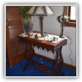F31. Carved flame mahogany trestle table. Dimensions: 29"W x 18"D - $195