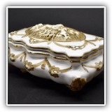 E7. Porcelain box with cherubs. Dimensions: 5"D x 8"W x 3.75"T - $14