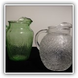 K27. 2 Glass pitchers. Green 9"T. Clear 8.5" - $8