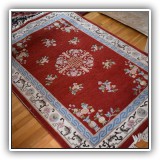 D7. Red ground Asian-style rug. Measures approximately: 6'1" x 4'2" - $125
