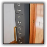 F33. Gray metal file cabinet