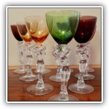 G01. 10 Multicolored Manchester Glass wine glasses with Art Deco nude stems. One glass with chip. - $275 for the set