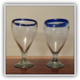 G02. Pair of blue rimmed goblets.  One chipped on base. 7"h - $6 for the pair