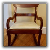 F41. Wooden child's rocking chair with cream colored dragonfly upholstery. 20"h x 15"w x 18"d - $68