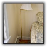 D42. Standing brass floor lamp with arm. - $60