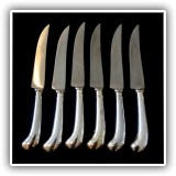 S10. Set of 6 steak knives with silver handles. - $30