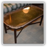 F5. Brass coffee table on stand.  Chips to edge of glass on surface. 18"h x 42.5"w x 22.5"d - $175