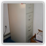 F56. Four-drawer metal file cabinet. 52"h x 15"w x 25"d - $30