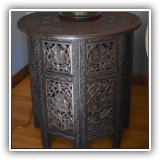 F04. Carved round side table with mother-of-pearl inlay. (Two pieces of inclay are missing.) 21.5"h x 21"w - $175