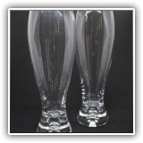 G02. Pair of pilsner glasses. One with a small chip. - $6 for the pair