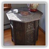 F05. Hexagonal carved side table with brass inlay. 25"h x 23.5w - $195