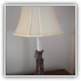 D19. Small ceramic candlestick lamp with shield decoration. - $30