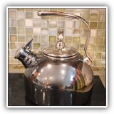 K15. Chrome colored tea kettle