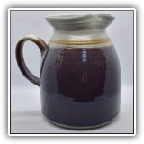 P60. Studio Pottery pitcher with purple glaze. Signed. 7"h