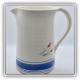 P61. Pitcher with blue stripes and flower design