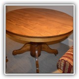 F55. Round oak dining table with 2 10" leaves.  Chip to top. 28"h x 45"w  - $350
