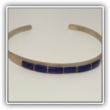 J14. Silvertone bracelet with blue stones. - $14